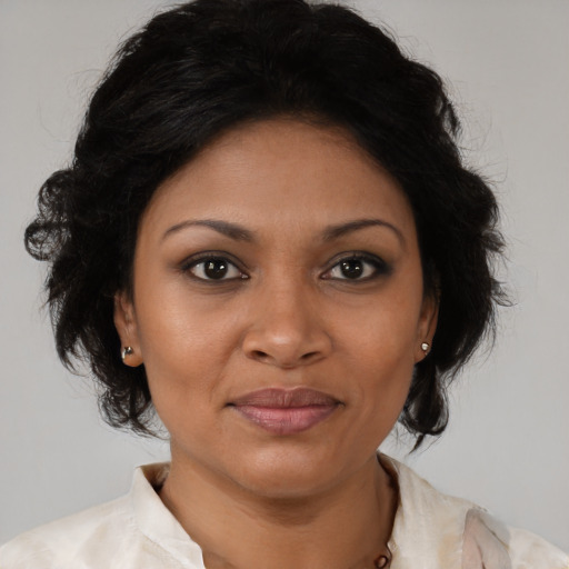 Joyful black young-adult female with medium  brown hair and brown eyes