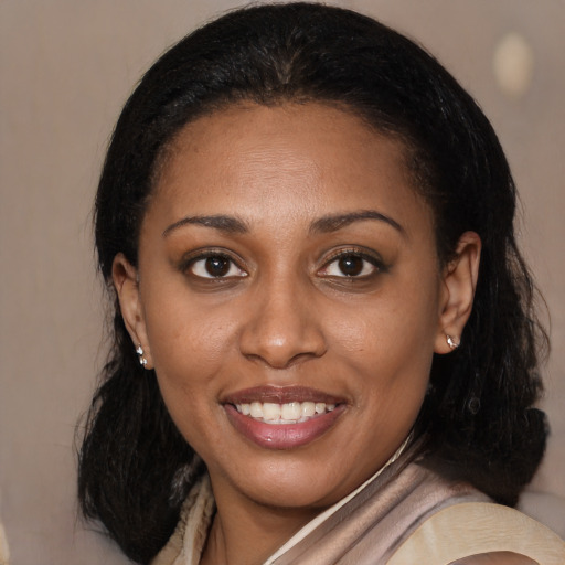 Joyful black young-adult female with medium  brown hair and brown eyes