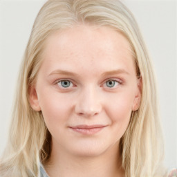 Joyful white young-adult female with long  brown hair and blue eyes