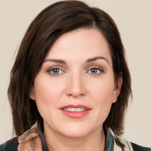 Joyful white young-adult female with long  brown hair and grey eyes