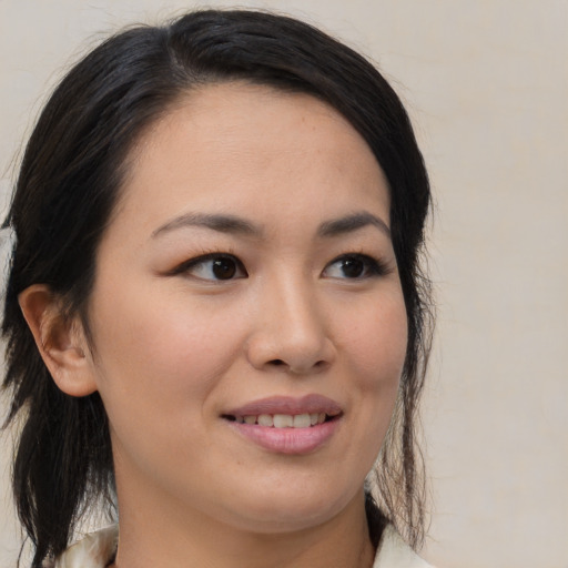 Joyful asian young-adult female with medium  brown hair and brown eyes