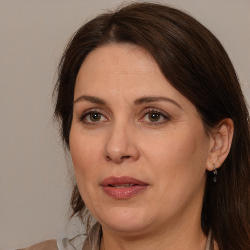 Joyful white adult female with medium  brown hair and brown eyes