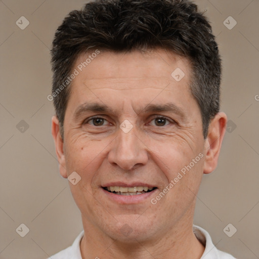 Joyful white adult male with short  brown hair and brown eyes