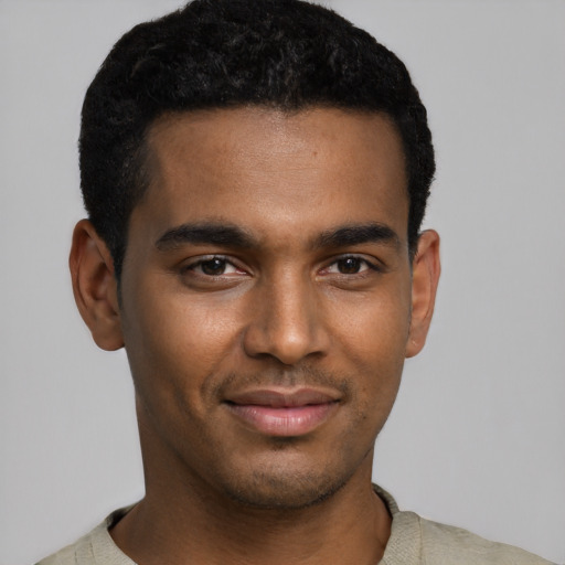Joyful black young-adult male with short  black hair and brown eyes