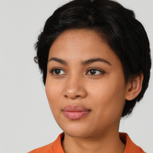 Joyful latino young-adult female with medium  black hair and brown eyes