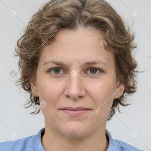 Joyful white adult female with medium  brown hair and blue eyes