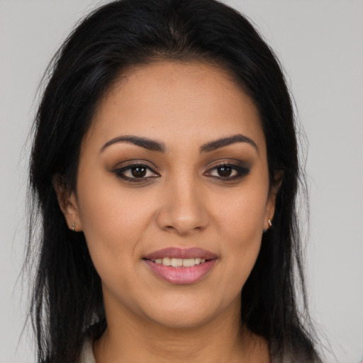 Joyful latino young-adult female with long  brown hair and brown eyes
