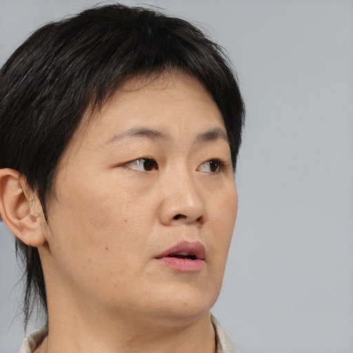 Neutral asian adult male with short  brown hair and brown eyes
