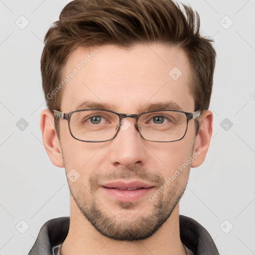 Joyful white young-adult male with short  brown hair and grey eyes