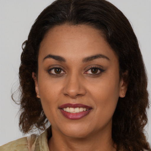 Joyful latino young-adult female with medium  brown hair and brown eyes