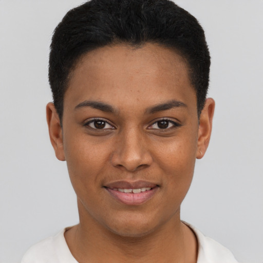 Joyful black young-adult female with short  black hair and brown eyes