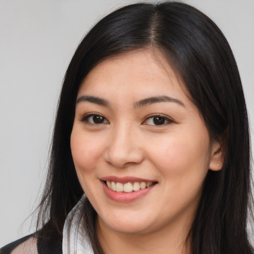 Joyful white young-adult female with long  black hair and brown eyes