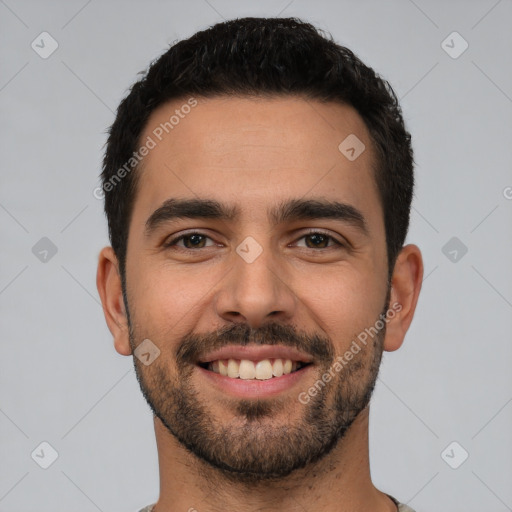 Joyful white young-adult male with short  black hair and brown eyes