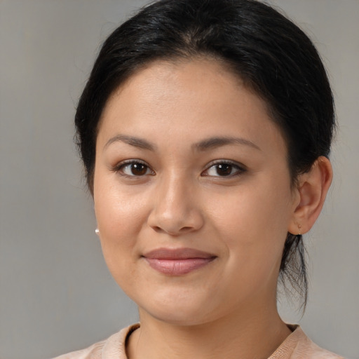 Joyful latino young-adult female with medium  brown hair and brown eyes