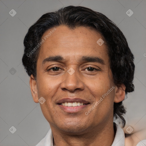 Joyful latino adult male with short  black hair and brown eyes