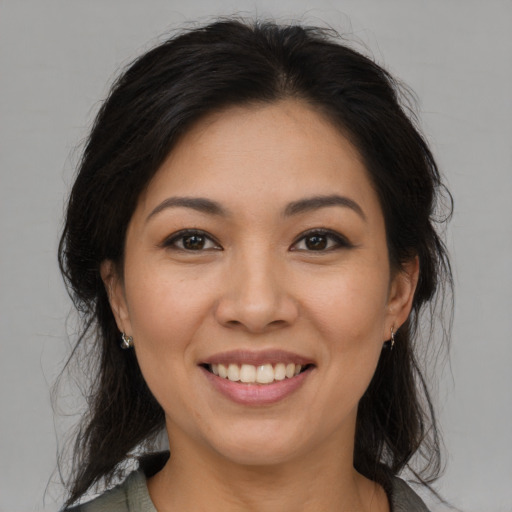 Joyful asian young-adult female with medium  brown hair and brown eyes