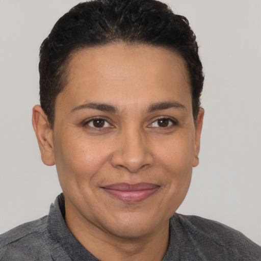Joyful latino adult female with short  brown hair and brown eyes
