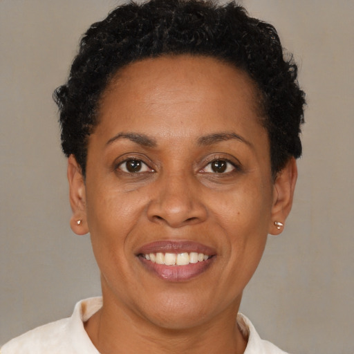 Joyful black adult female with short  brown hair and brown eyes
