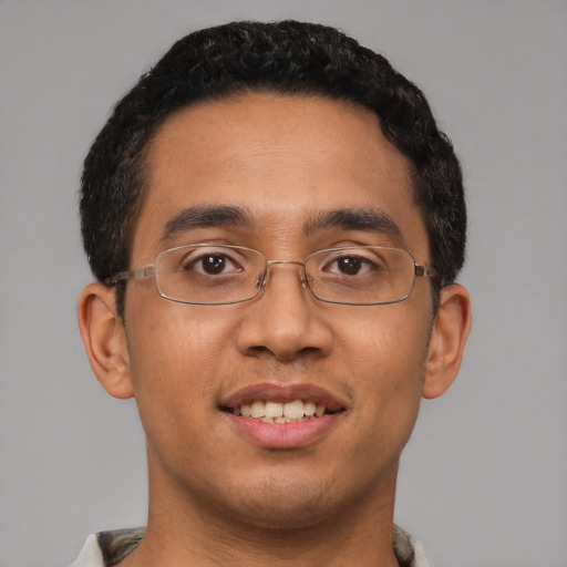 Joyful latino young-adult male with short  brown hair and brown eyes