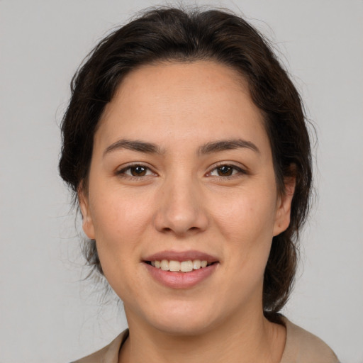 Joyful white young-adult female with medium  brown hair and brown eyes