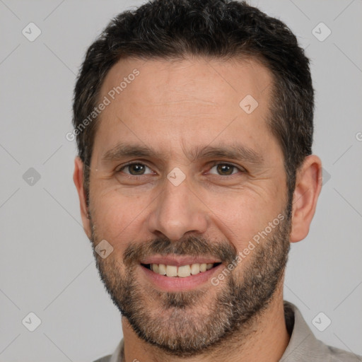 Joyful white adult male with short  brown hair and brown eyes