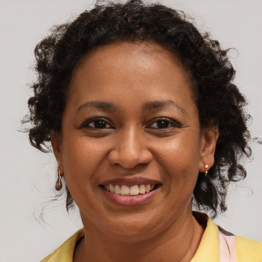 Joyful black adult female with short  brown hair and brown eyes
