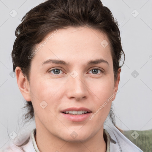 Joyful white young-adult female with short  brown hair and grey eyes