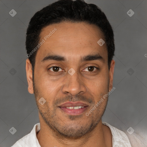 Joyful latino young-adult male with short  black hair and brown eyes