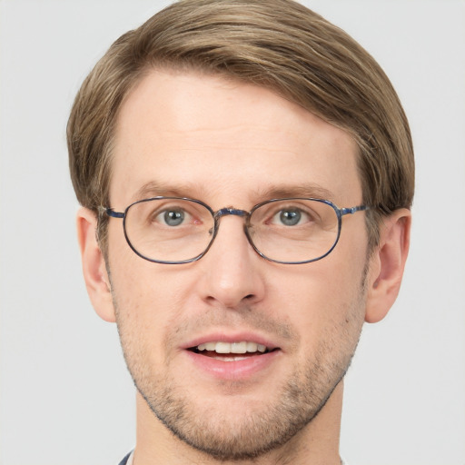 Joyful white adult male with short  brown hair and grey eyes