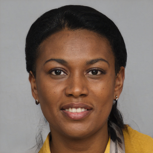 Joyful black young-adult female with short  black hair and brown eyes
