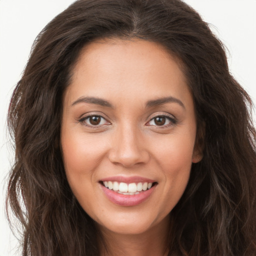 Joyful white young-adult female with long  brown hair and brown eyes