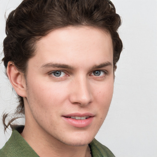 Joyful white young-adult male with medium  brown hair and grey eyes