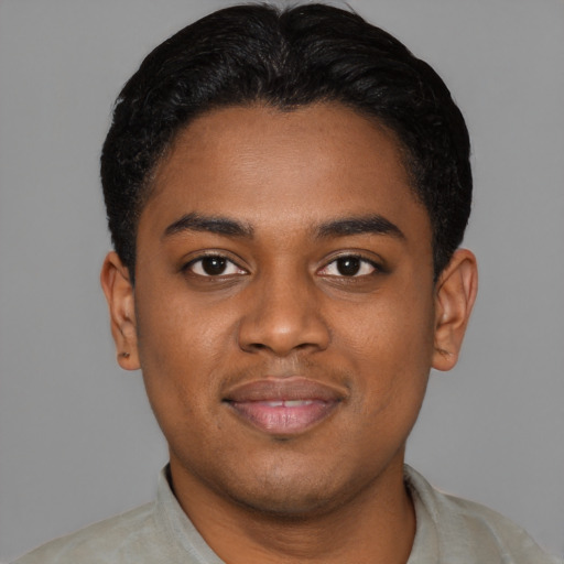 Joyful black young-adult male with short  black hair and brown eyes