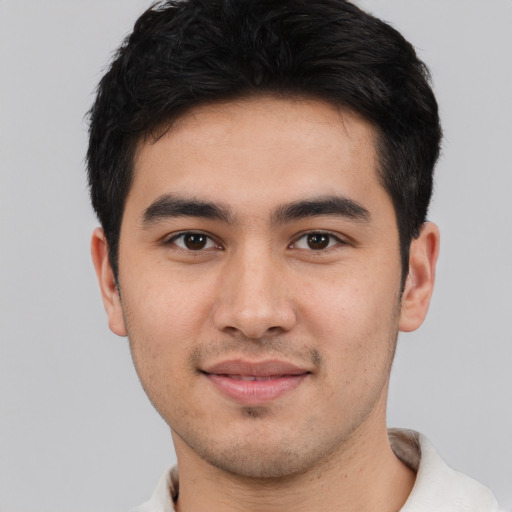 Joyful white young-adult male with short  black hair and brown eyes