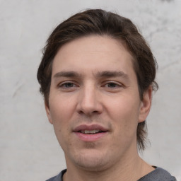 Joyful white adult male with short  brown hair and grey eyes