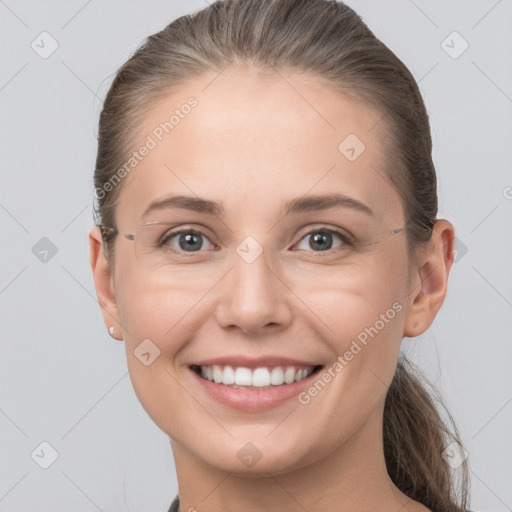 Joyful white young-adult female with short  brown hair and grey eyes