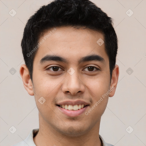 Joyful latino young-adult male with short  black hair and brown eyes