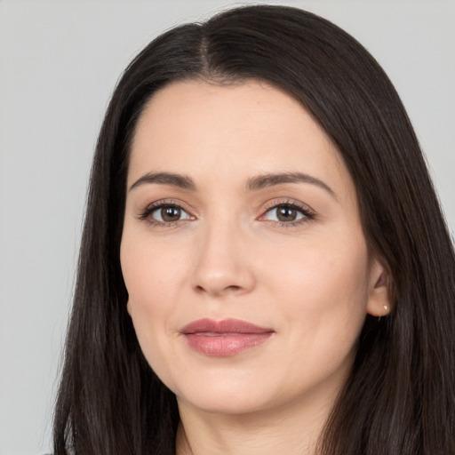 Joyful white young-adult female with long  black hair and brown eyes