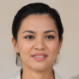 Joyful latino young-adult female with medium  brown hair and brown eyes