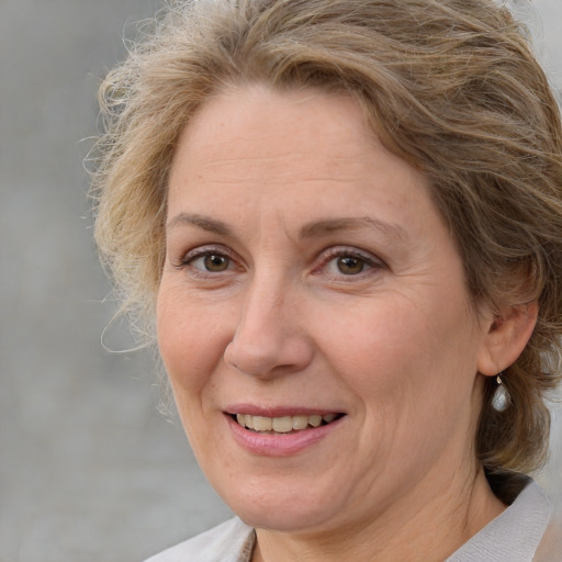 Joyful white adult female with medium  brown hair and brown eyes