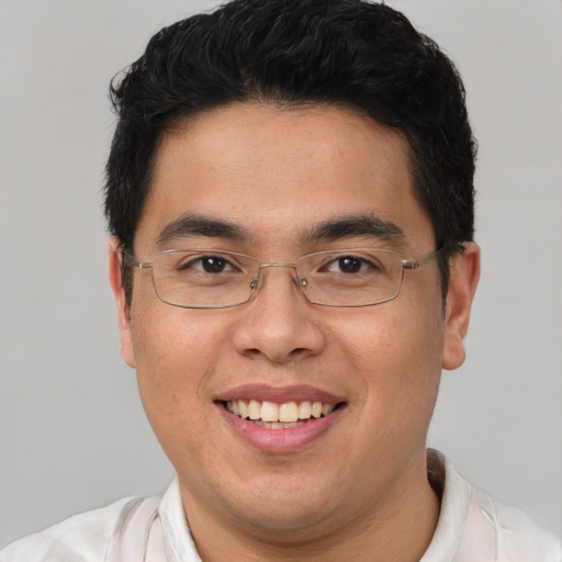 Joyful asian young-adult male with short  brown hair and brown eyes