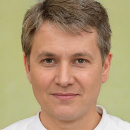 Joyful white adult male with short  brown hair and brown eyes