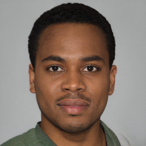 Joyful black young-adult male with short  brown hair and brown eyes