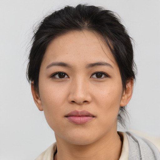 Joyful asian young-adult female with medium  brown hair and brown eyes