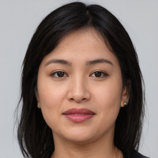 Joyful asian young-adult female with long  brown hair and brown eyes
