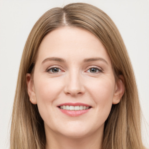 Joyful white young-adult female with long  brown hair and grey eyes