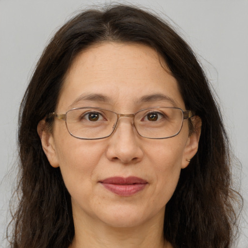 Joyful white adult female with long  brown hair and brown eyes