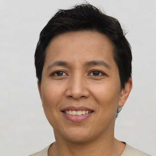 Joyful asian adult female with short  brown hair and brown eyes
