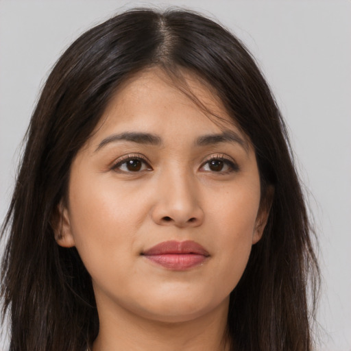 Joyful latino young-adult female with long  brown hair and brown eyes