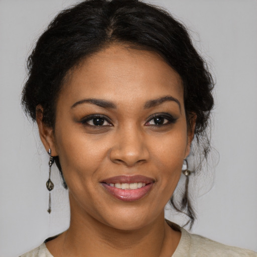 Joyful black young-adult female with medium  brown hair and brown eyes